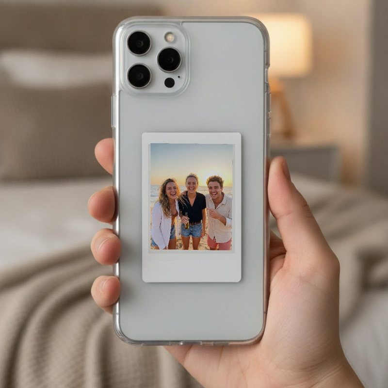 An Instax Mini print in the card pocket of a clear phone case